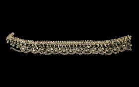 White Metal Decorative Anklet, with chains and bobbles that move with you, making a tinkling sound.