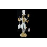 Murano Glass Figure of a Blackamoor, in white with gilt trims, figure holding aloft a candle holder,