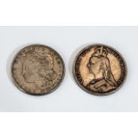 A 1921 Peace Dollar and 1892 Victorian Crown both in worn condition.