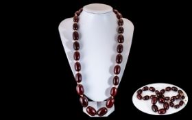 A Faux Cherry Amber Bead Necklace, each bead individually knotted. Length 28", weight 135 grams.