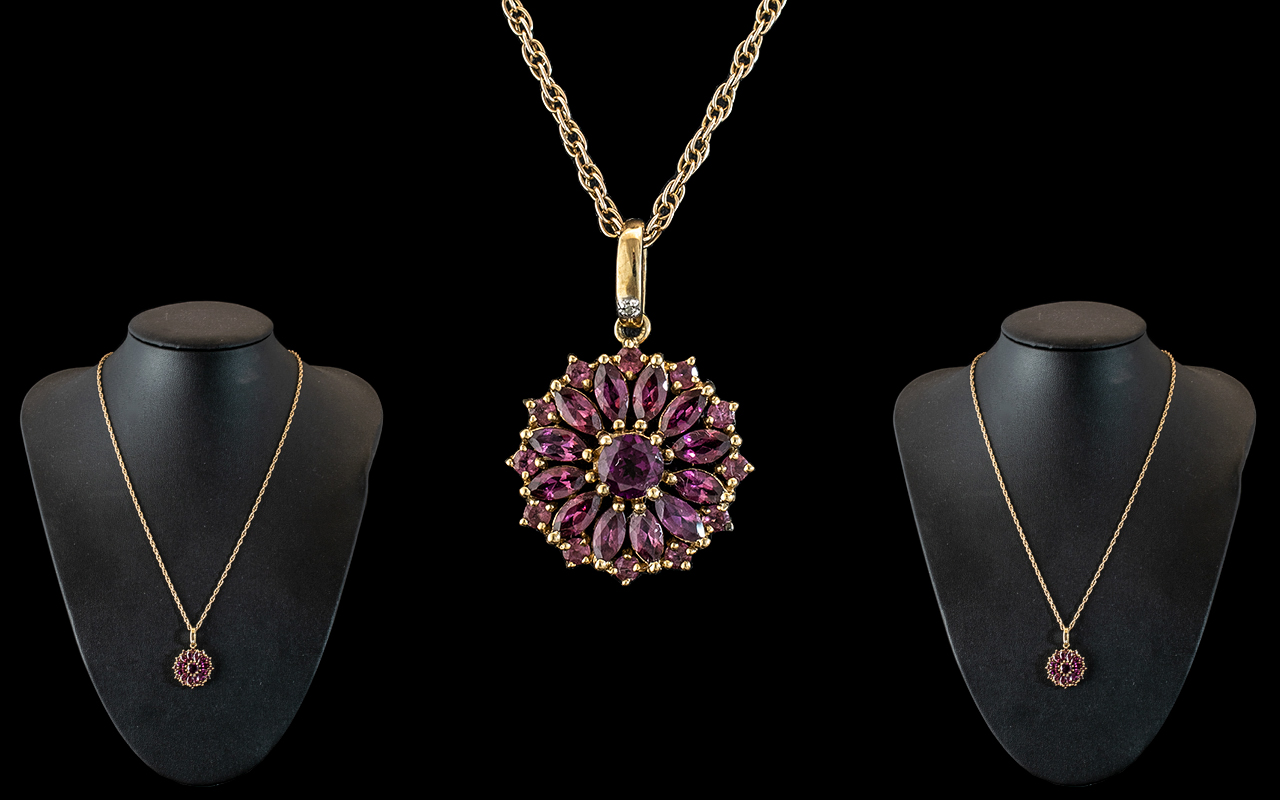 9ct Gold Pendant Set with Amethysts of Excellent Colour - Attached to a 9ct Gold Chain.