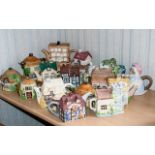 A Collection of Novelty Teapots including three fine china tea pots by Christopher Wren "Cottages"
