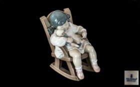 Lladro Figure No. 5.448, 'Naptime', depicting a sleepy little girl in a chair.