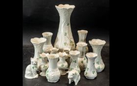 Quantity of Belleek Pottery, comprising assorted vases, of various sizes and designs, the tallest