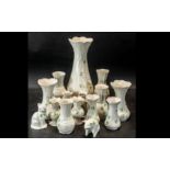 Quantity of Belleek Pottery, comprising assorted vases, of various sizes and designs, the tallest