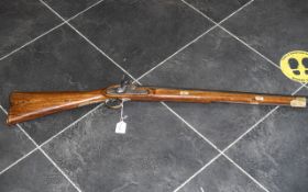 A 19th Century Percussion Riffle unmarked steel fitting and barrel, brass mount and trigger guard.