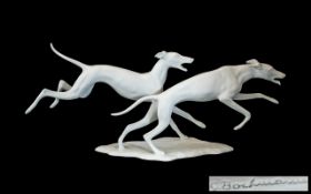 Kaiser Porcelain Bisque Figure Group of Two Running Dogs, Length 12 Inches.