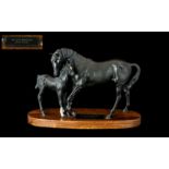 Beswick 'Black Beauty & Foal' raised on a wooden base. Measures approx 8'' tall x 12'' wide.
