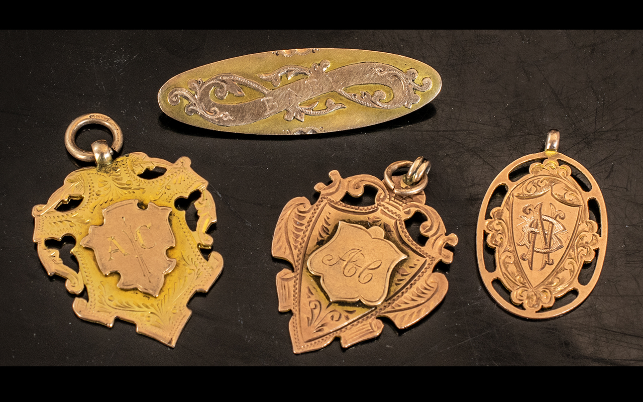 Three 9ct Gold Watch Fobs, early 20th Century, together with a 9ct gold baby brooch,