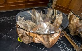 Root Wood Glass Top Coffee Table, of modern abstract form. Circular glass top held in place with