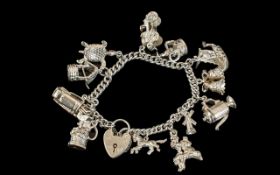 A Good Quality Vintage Sterling Silver Charm Bracelet Loaded with 13 Silver Charms of Various
