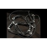 A Single Strand Hematite Necklace, 20'' long, with a magnetic clasp, together with a three strand