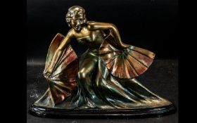 An Art Deco Style Centre Piece depicting a dancing girl with fans, Raised on an oval plinth,