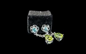 Aquamarine and Peridot Drop Earrings, each having a pear cut peridot suspended, on a fine chain,