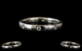 A Platinum Diamond Set Wedding/Eternity Ring, set with eight round brilliant cut diamonds,