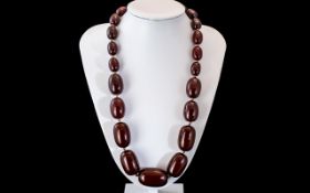 A Faux Cherry Amber Bead Necklace, each bead individually knotted. Length 60 cm, weight 140 grams.
