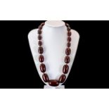 A Faux Cherry Amber Bead Necklace, each bead individually knotted. Length 60 cm, weight 140 grams.