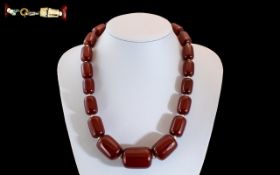 1920's Fine Quality Barrel Shaped Graduated Cherry Amber Necklace with Bone Clasp and Spacers.