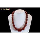 1920's Fine Quality Barrel Shaped Graduated Cherry Amber Necklace with Bone Clasp and Spacers.