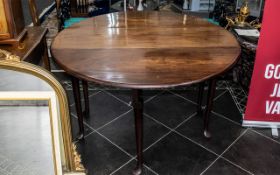 Drop Leaf Table raised on cabriole legs, with two lift up sides, finished in a polished oak wood,