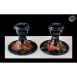 William Moorcroft Signed Pair of Swat Candlesticks In the ' Pomegranates ' Design on Blue Ground. c.