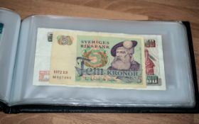 Collection of 40 World Bank Notes, housed in a blue paper money collection book,