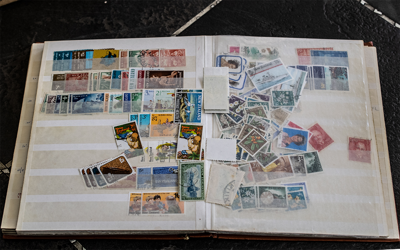 Thick A5 stamp stock book bursting at the seams with stamps from Australia and New Zealand.
