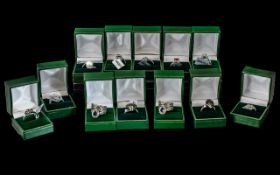 Collection of Twelve Silver Dress Rings, set with coloured crystals, stones, pearls, etc.