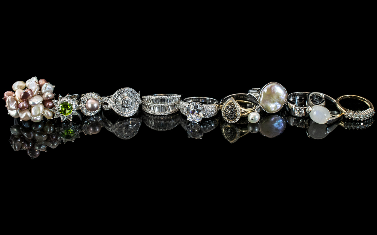 Collection of Twelve Silver Dress Rings, set with pearls and crystals,