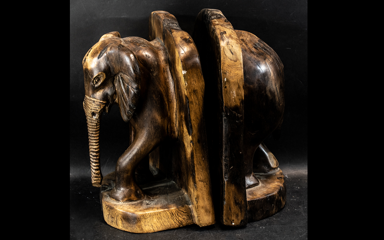 Large Antique Wooden Bookends in the form of elephants, the bookends showing African Bull elephants;