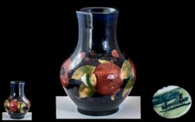 William Moorcroft Tubelined Bulbous Vase 'Pomegranates' on a blue ground, c1920s,