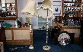 A Pair of Onyx and Brass Standard Lamps, of typical form with tasselled shades.