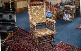 An American Beechwood Rocking Chair, with a padded back rest, seat and arm rests. Turned support.