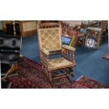 An American Beechwood Rocking Chair, with a padded back rest, seat and arm rests. Turned support.