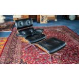 Contemporary Eames Style Black Leather upholstered and walnut lounge chair with stool.