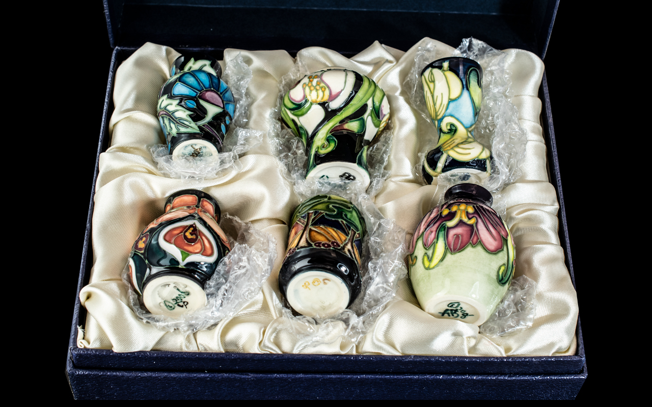 Boxed Collection of Six Miniature Tubelined Moorcroft Vases,various designs and shapes, circa 2006,