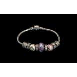 Pandora Signed Sterling Silver Bracelet loaded with 9 silver charms weight 34.8 grams.