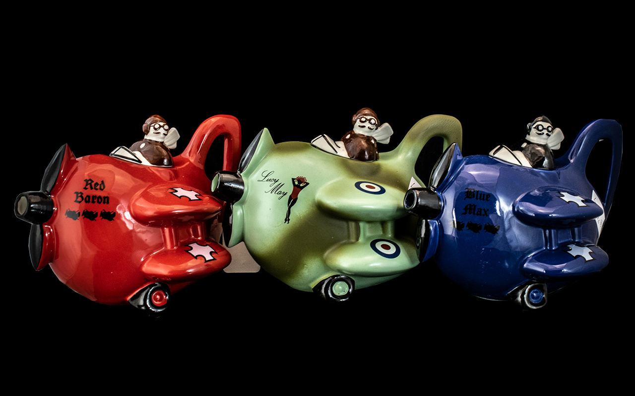Three Carlton Ware Novelty Tea Pots Modelled as Bi-Planes, Red Baron, Lucy May and Blue Max.