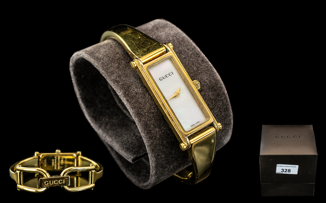 Ladies Gucci Bracelet Watch, No.1500L, pearl face with gold hands, gold tone bracelet.