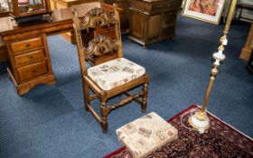 A Bedroom/Hall Chair in Oak, heavily carved in the Priory style, recently upholstered seat and