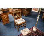 A Bedroom/Hall Chair in Oak, heavily carved in the Priory style, recently upholstered seat and