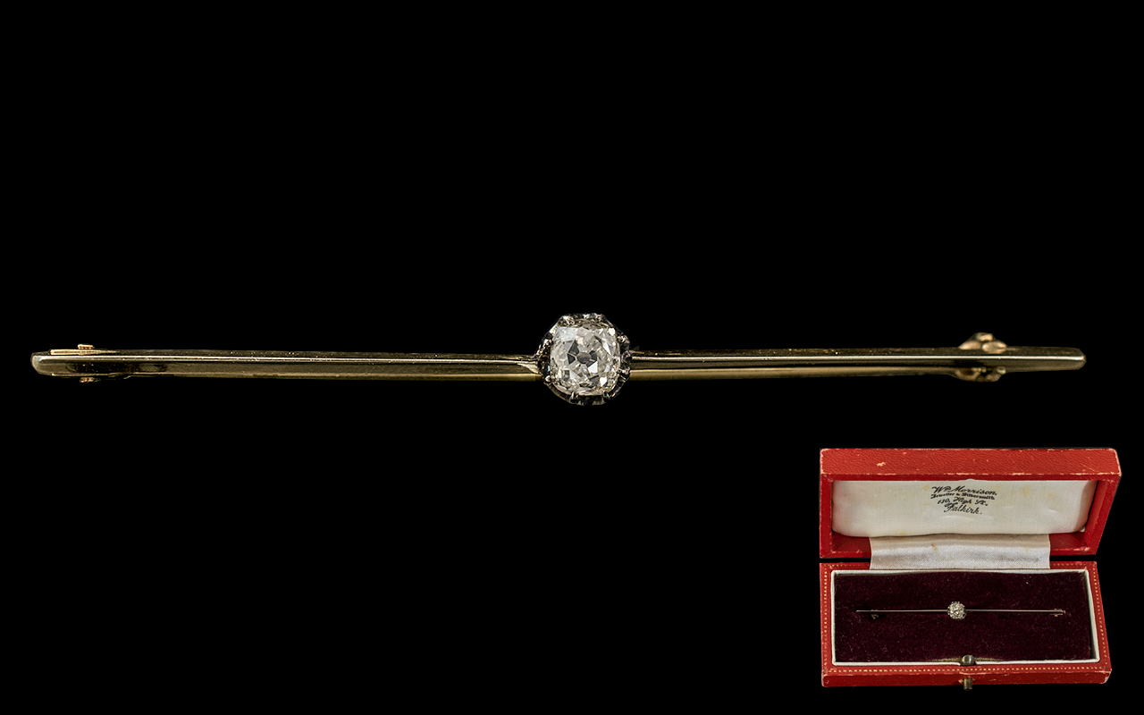 A Victorian Gold Bar Brooch Set with a Central Old Cut Diamond approximately 30 pts. Length - 67 mm.