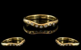 An 18ct Gold Diamond Ring Set with Seven Round Brilliant Cut Diamonds. Ring Size O. Weight 4 grams.