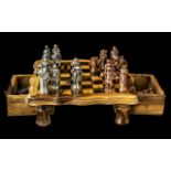 A Small Size Wood Chess Set with gold coloured historic figures as chess pieces.