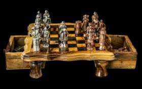 A Small Size Wood Chess Set with gold coloured historic figures as chess pieces.