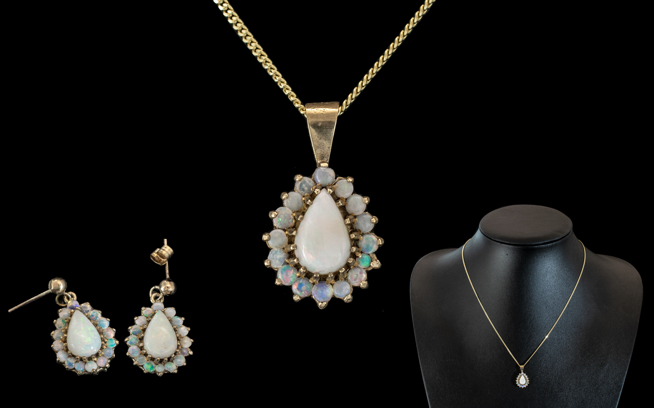 A 9ct Opal Pendant and Earring Set each set with a central pear shaped opal,