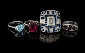 Three Silver Rings set with Garnets, blue and red faceted stones, hallmarked for silver.