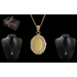 Ladies 9ct Gold Diamond Set Hinged Locket of oval form with attached 9ct gold chain,