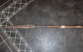 An African Wood Shafted Spear together with one other without the shaft.