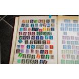 Red A4 stock book of British stamps. Lot
